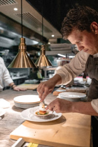 Culinary Director Chef Freddy Money at Atlas plating his dish