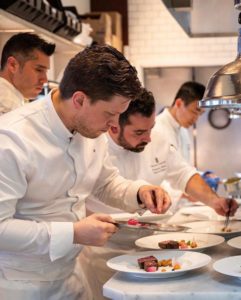 Culinary Director Chef Freddy Money at Atlas in the kitchen with his team